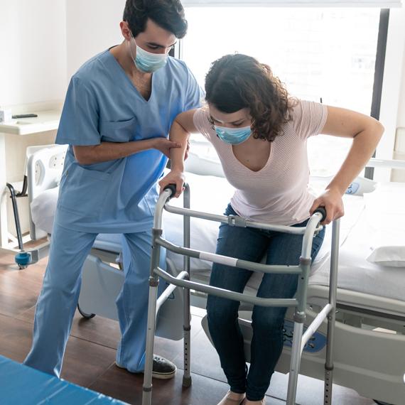 caregiver helping patient stand up